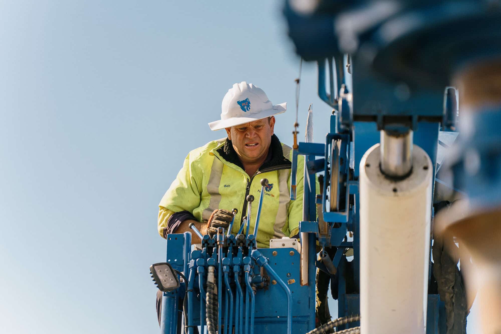 PLT operator in hi-vis at the drilling rig controls